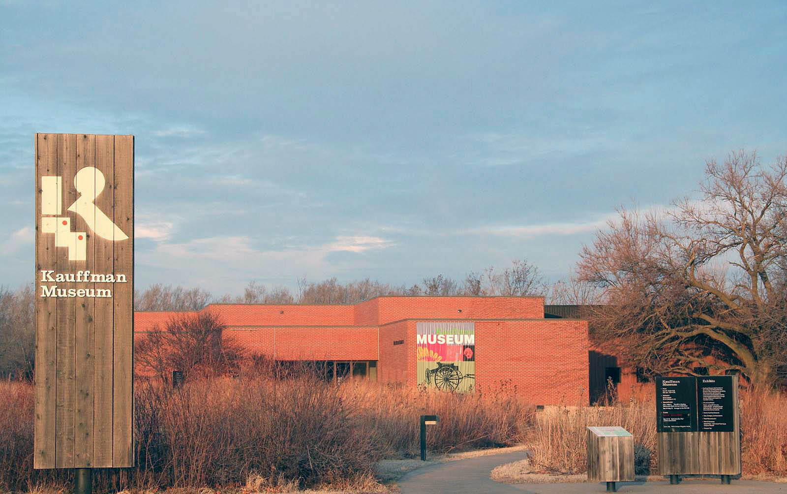Exterior of Kauffman Museum on a sunny winter day, with a museum banner on the side of the building