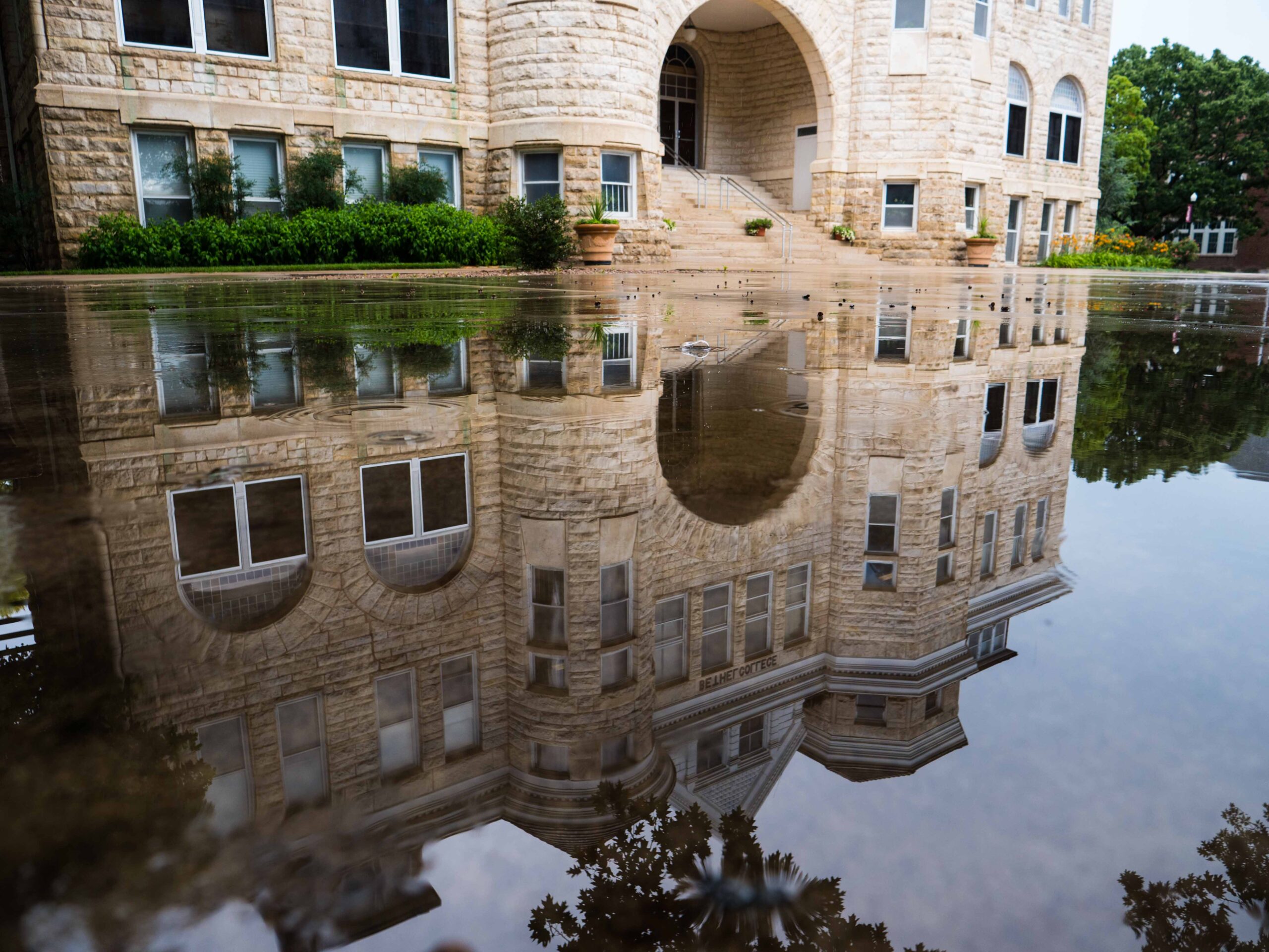Ad Building reflected in a large puddle