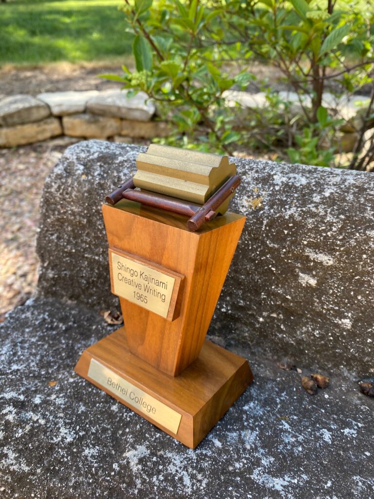 A Thresher Award from the 1960s, etched with the name Shingo Kajinami, and the subject area, Creative Writing