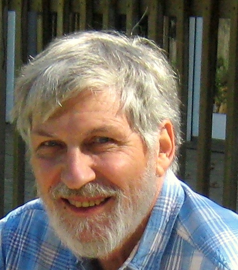 Headshot of David Janzen in blue-checked shirt