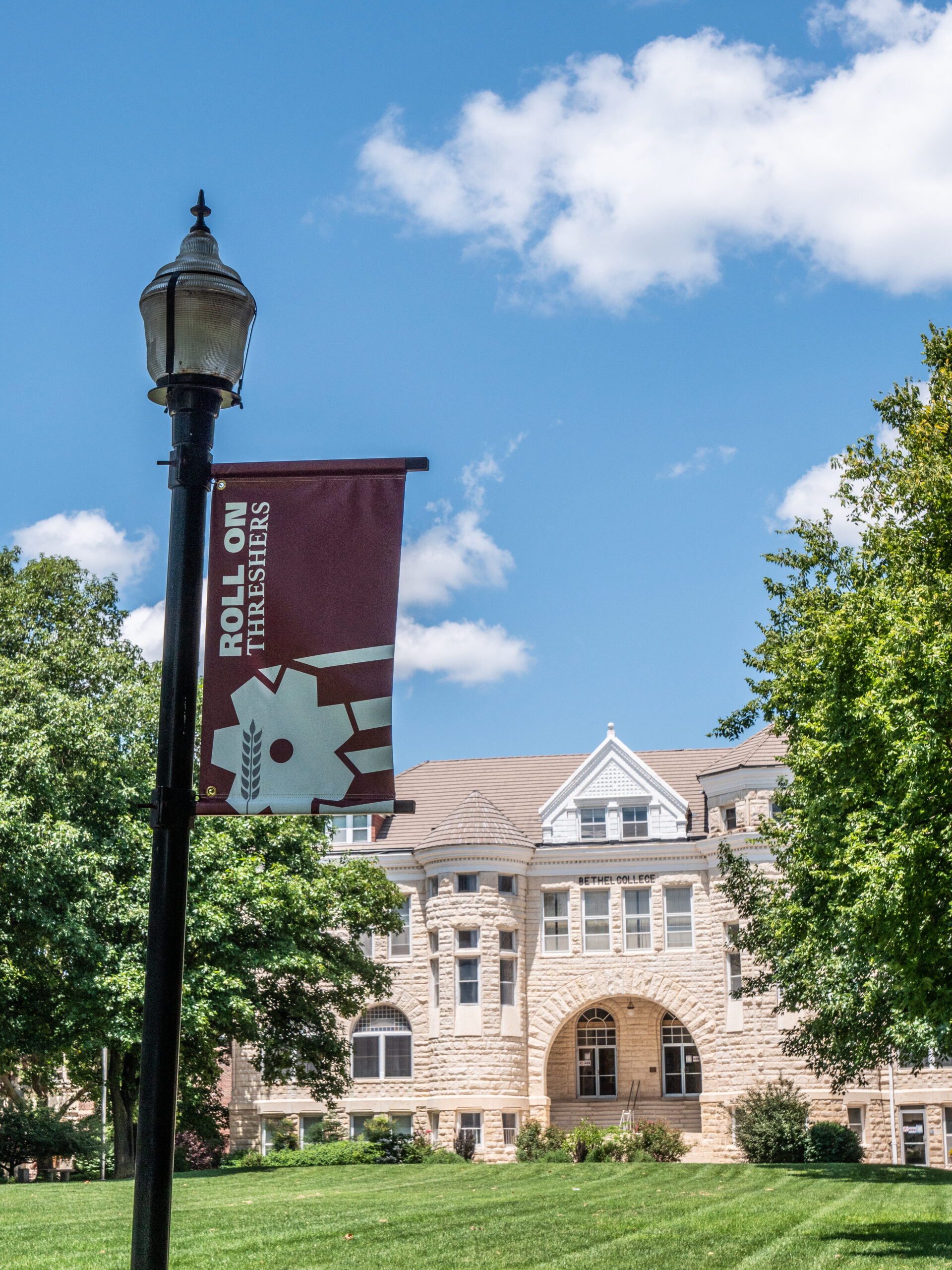 Bethel "Roll On" banner with Ad Building in background
